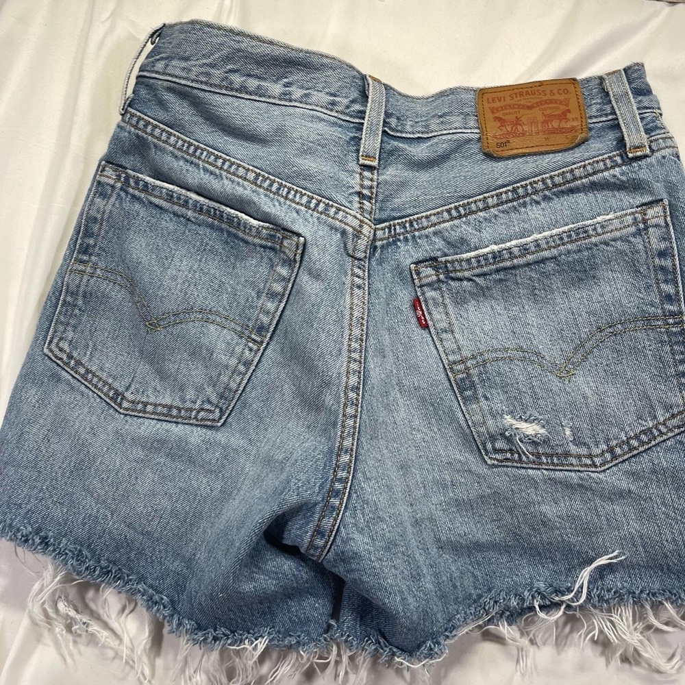 Levi’s original 501 Womens denim button fly shorts with frayed hem. Size: 4